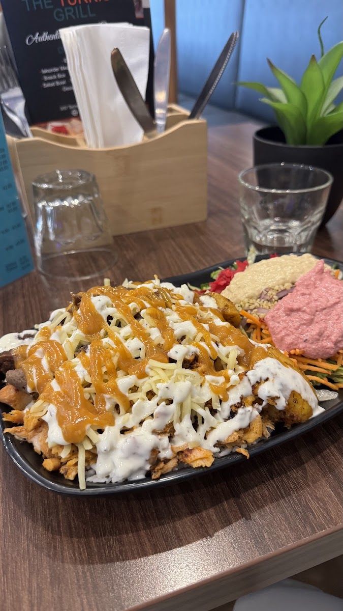 Meat on chips with sauces and dips